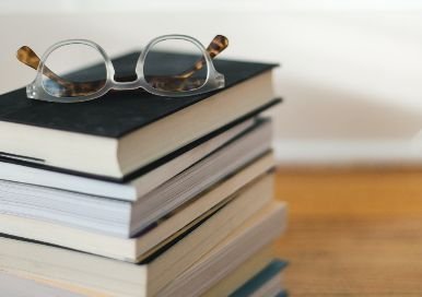 Stack of books with glasses on top