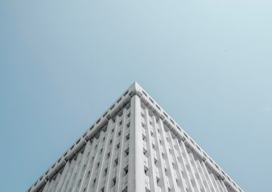 Corner of a white office building shot from below