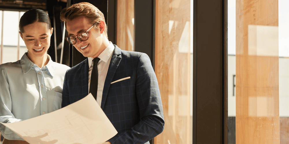 Two business people talking over some documents 