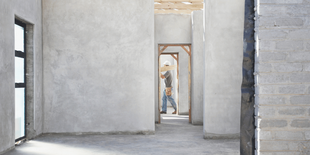 Construction worker carrying a wooden beam