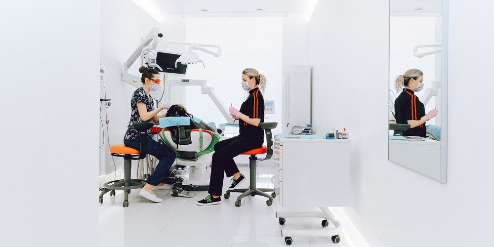 Dentists doing a procedure on a patient