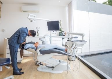 Dentist working on a patient in a chair