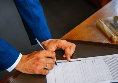 A man signing a document