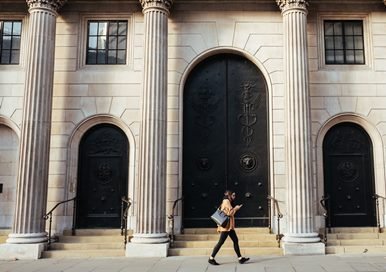 Lady walking in front of a bank