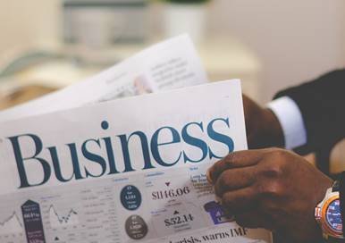 A man reading Business newspapers