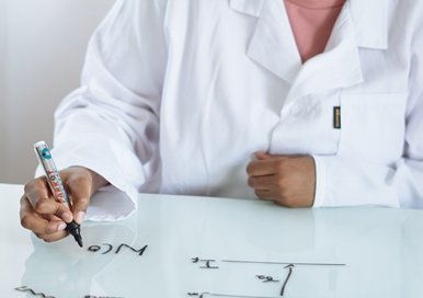 A medical worker writing on a white board