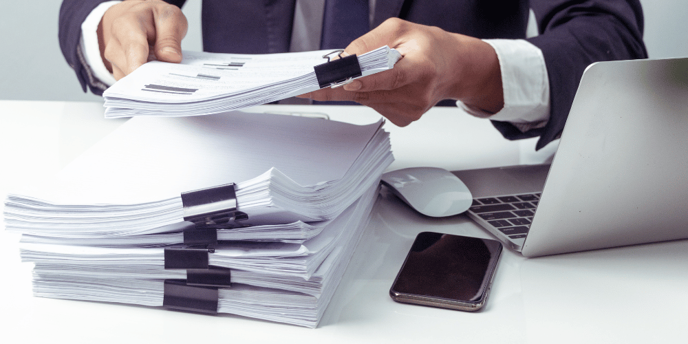 man holding a bunch of documents