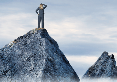 Woman in a suit standing on a mountain