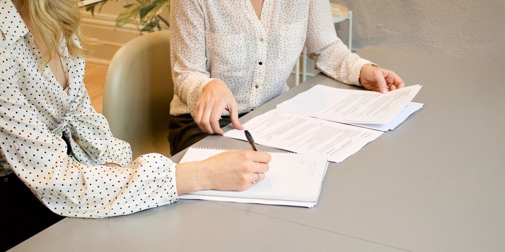 Women signing documents